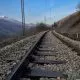 Train tracks with snow-capped mountain peaks