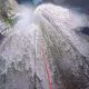 Canyoning rope down the big waterfall at Medjurecki Canyon