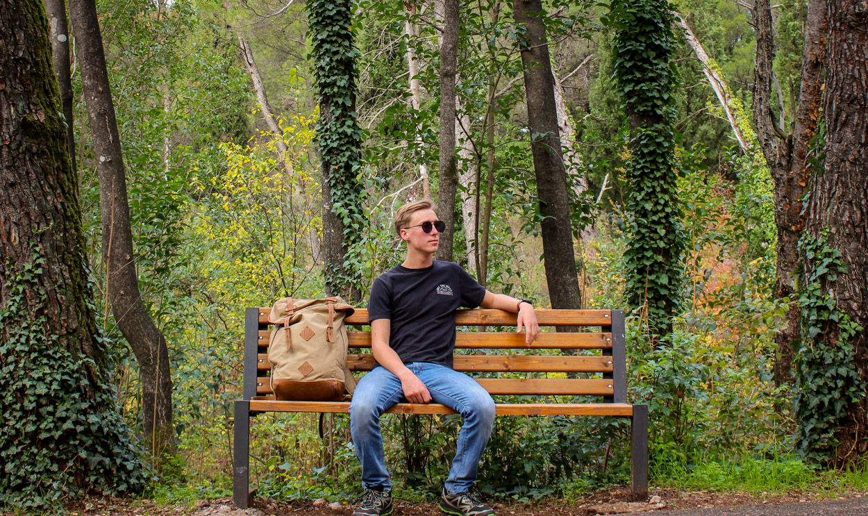 Blog author and adventurer, Noel Nelson, resting in Gorica Park in Podgorica