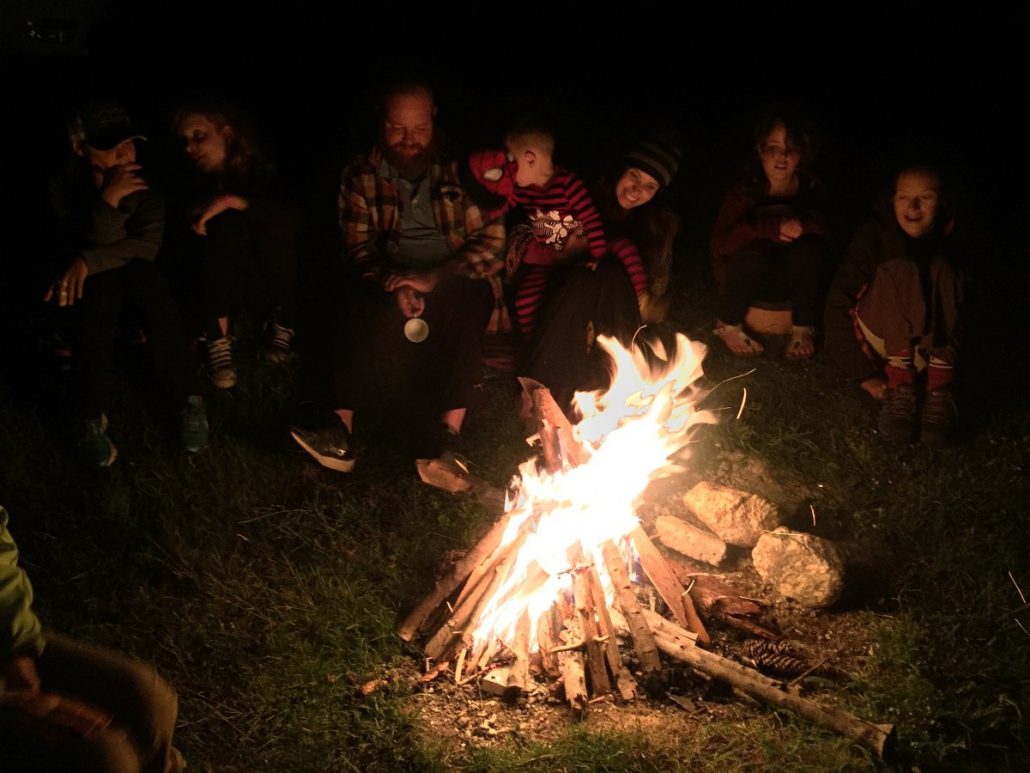 American families enjoying a bonfire during a family holiday getaway